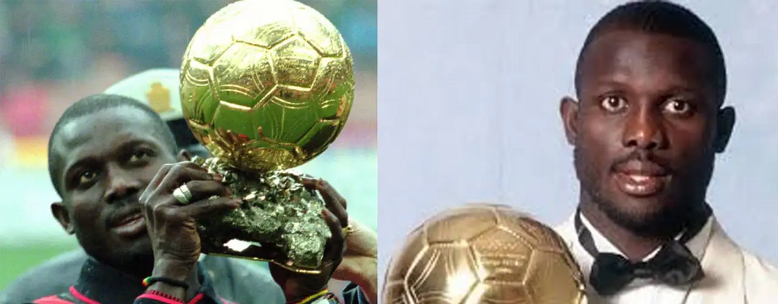 Soccer player holding Ballon d'Or trophy, stylish suit, Players Couture sports fashion context