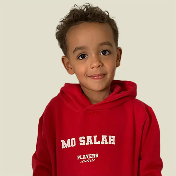 Young boy in red Players Couture Mo Salah hoodie, stylish sports fanwear apparel