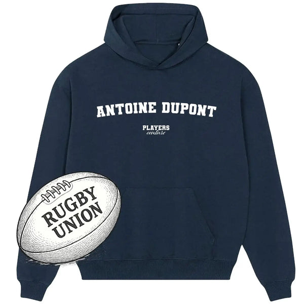 Navy Players Couture hoodie with Antoine Dupont text, rugby union ball graphic in front.