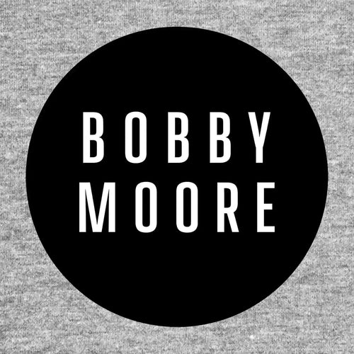 Bobby Moore Logo Men's T-Shirt – grey close-up detail shot of the Bobby Moore Players Couture logo design