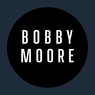 Bobby Moore Logo Men's T-Shirt – navy close-up detail shot of the Bobby Moore Players Couture logo design