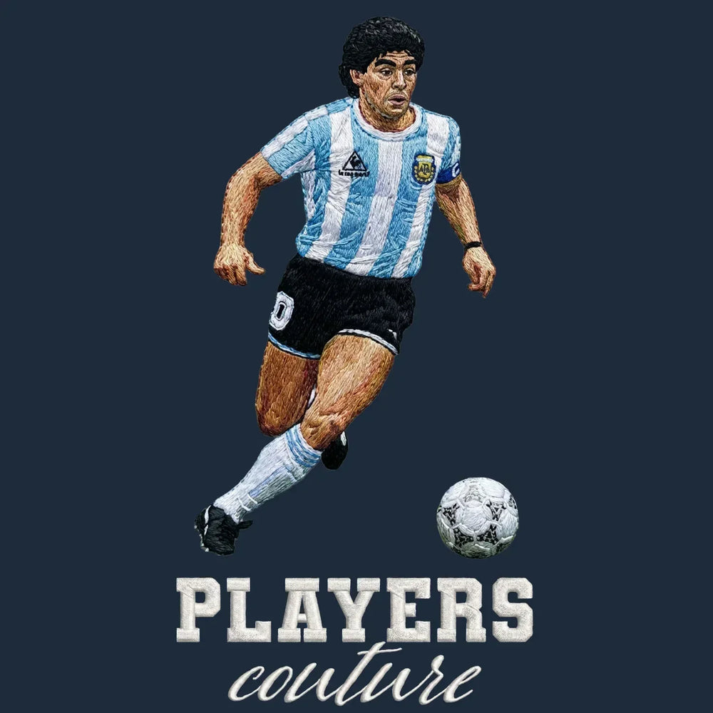 Diego Maradona Dribble Badge Men's Hoodie – navy close-up detail shot of the Diego Maradona Dribble Players Couture logo