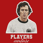 Franz Beckenbauer Badge Men's T-Shirt – red close-up detail shot of the Franz Beckenbauer Players Couture logo design