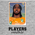 Gervinho World Cup Sticker Men's T-Shirt – grey close-up detail shot of the Gervinho World Cup Players Couture logo design