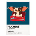 Gremlins Gizmo beside the mischievous Gremlins under Christmas lights in Kingston Falls Icon Frame artwork on white