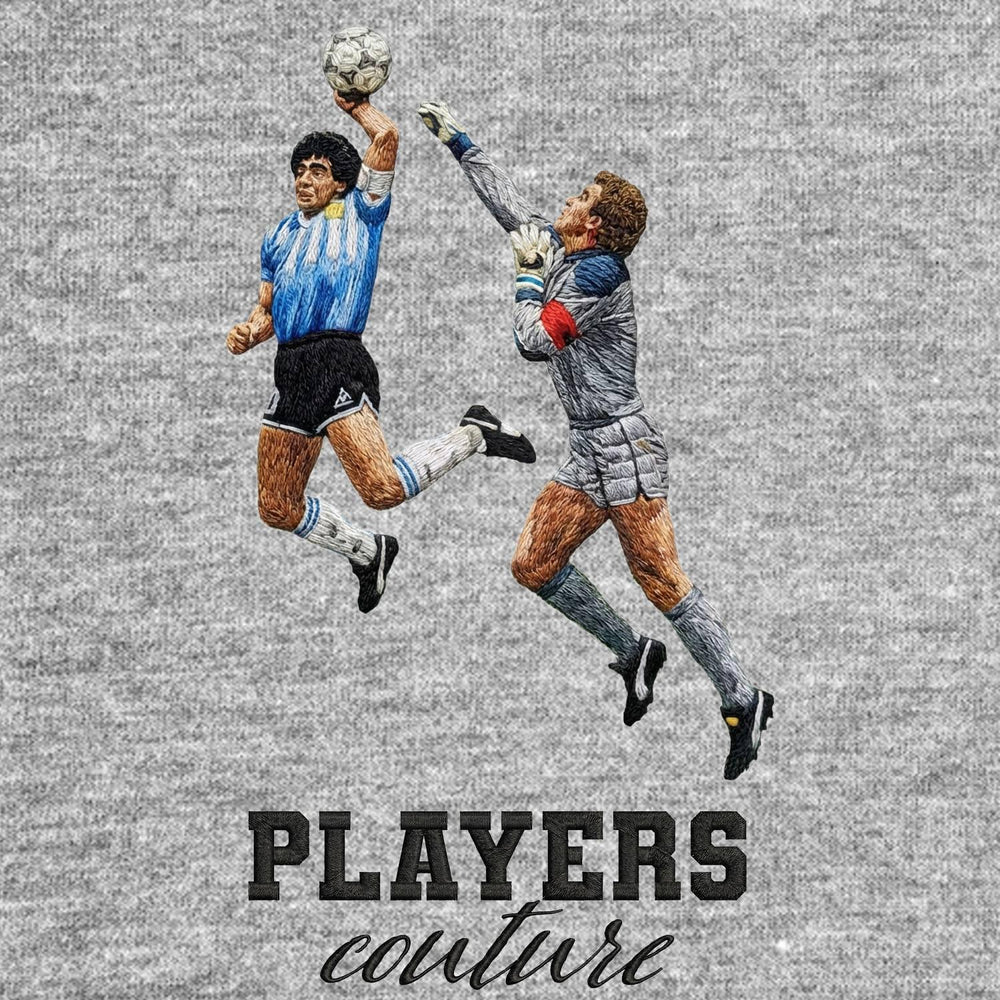 Maradona Hand of God Badge Men's T-Shirt – grey close-up detail shot of the Maradona Hand of God Players Couture logo design
