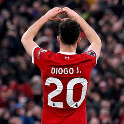 About Us - Football player in a red jersey with 'Diogo J.' and number '20' making a heart shape with his hands in front of a crowd.