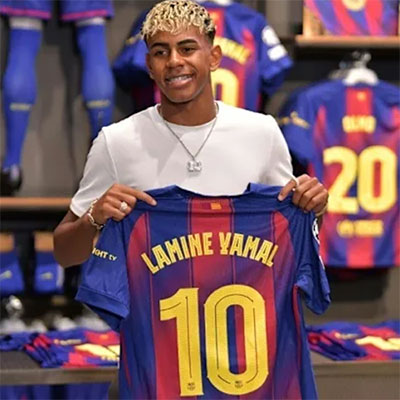 Shopping - Person holding a Barcelona jersey with 'Lahime Yamal' and number '10' in a store setting.