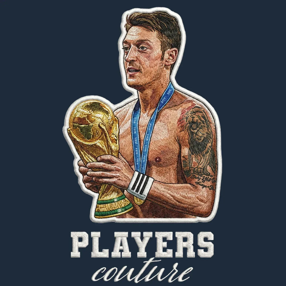 Mezut Ozil Badge Men's Hoodie – navy close-up detail shot of the Mezut Ozil Players Couture logo design