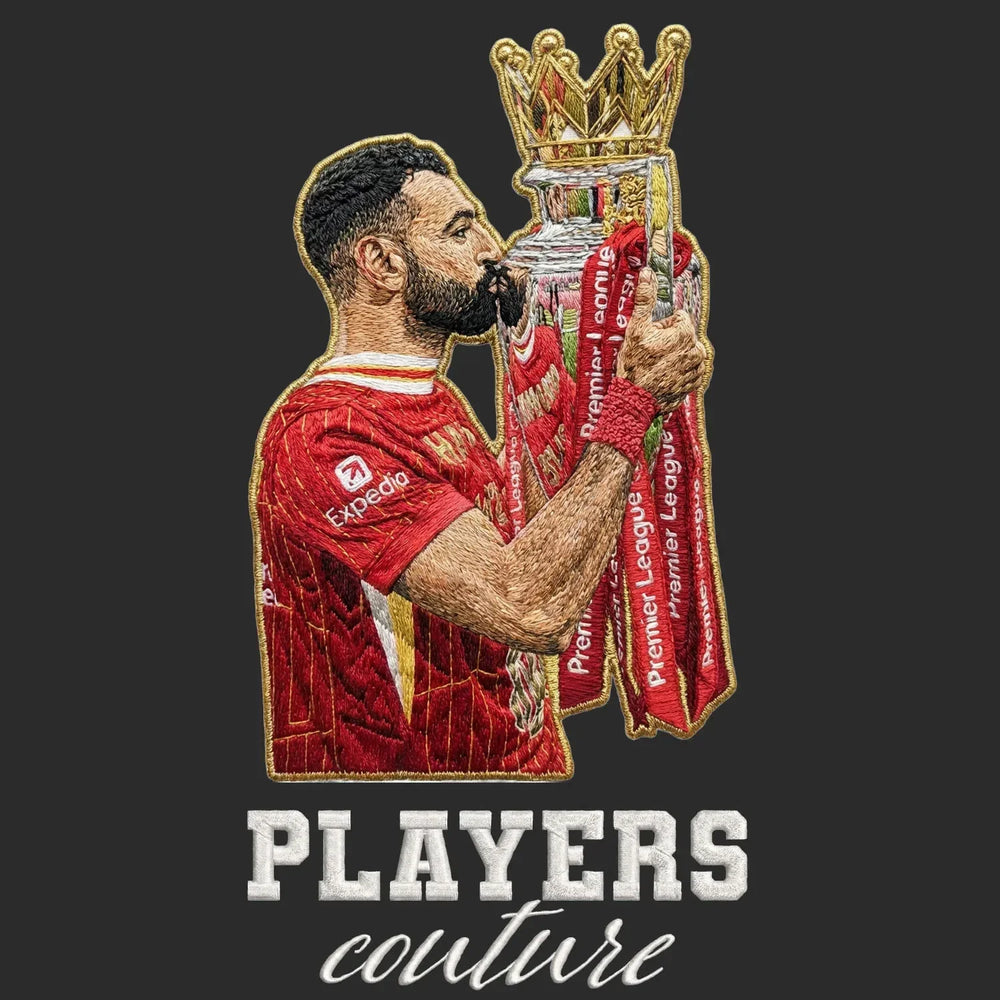 Mo Salah Champion Badge Men's T-Shirt – black close-up detail shot of the Mo Salah Champion Players Couture logo design