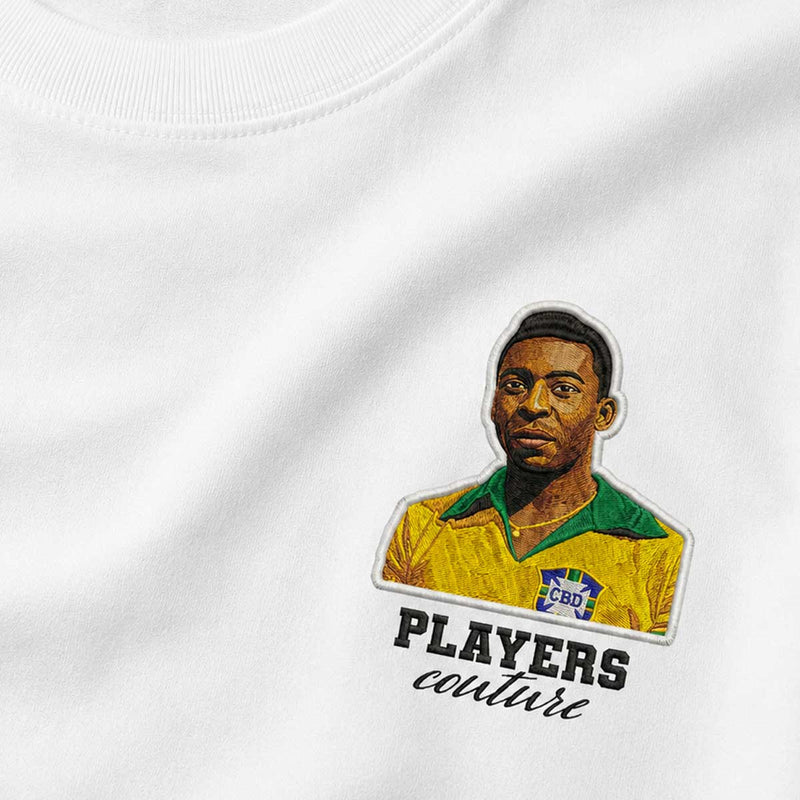 White t-shirt with a colorful patch of a person wearing a yellow jersey with 'Players Couture' text.