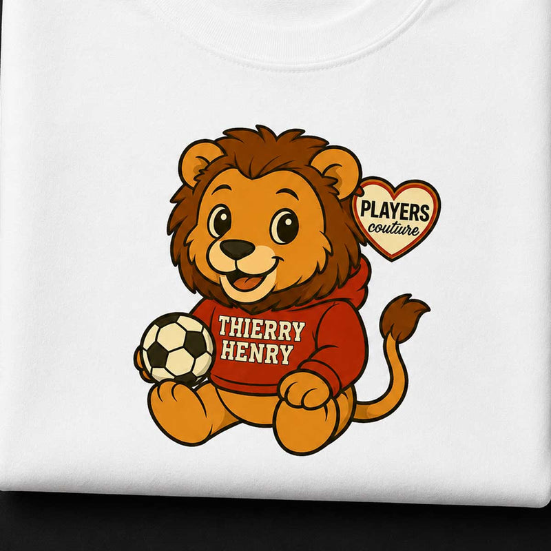 Lion character holding a soccer ball with 'Players Couture' logo on a white kids t-shirt background