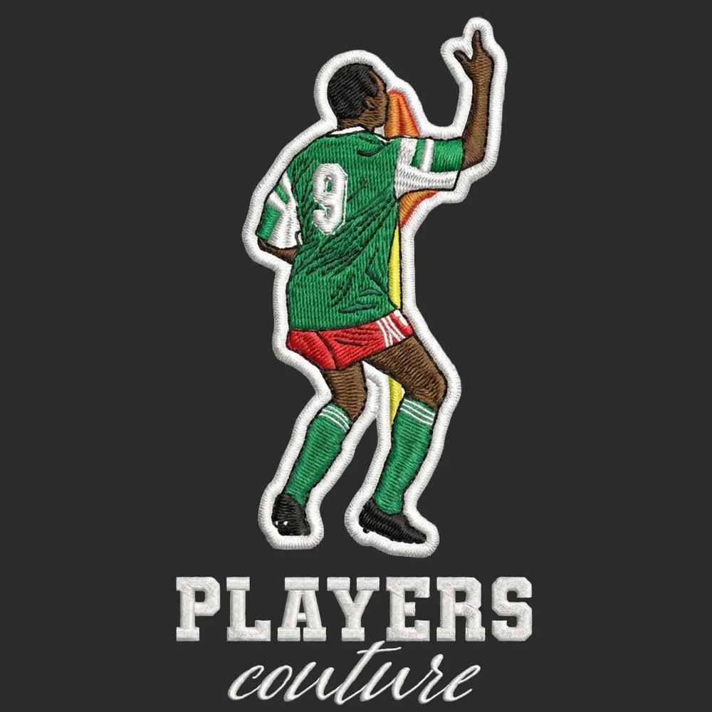 Roger Milla Badge Men's Hoodie – black close-up detail shot of the Roger Milla Players Couture logo design