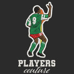 Roger Milla Badge Men's Hoodie – black close-up detail shot of the Roger Milla Players Couture logo design