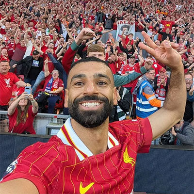 Social Media - Mo Salah taking selfie with Liverpool fans in the background
