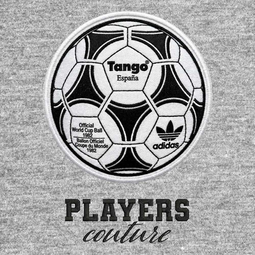 World Cup Tango Ball Badge Men's Hoodie – black close-up detail shot of the Tango Football Players Couture logo design
