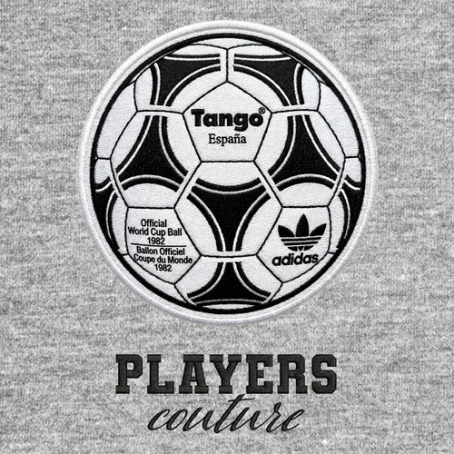 World Cup Tango Ball Badge Men's Hoodie – black close-up detail shot of the Tango Football Players Couture logo design