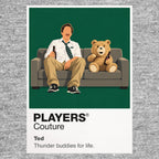 Ted John Bennett and his foul-mouthed childhood teddy bear sharing the sofa as inseparable adult friends Icon Frame artwork in grey