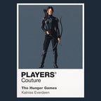 The Hunger Games Katniss Everdeen with bow and Mockingjay symbolism between District 12 and the Capitol arena Icon Frame artwork in navy