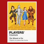 The Wizard of Oz Dorothy, Scarecrow, Tin Man and Cowardly Lion following the Yellow Brick Road towards Emerald City Icon Frame artwork in red