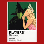 Wicked Elphaba and Glinda in contrasting green, pink and black silhouettes above the land of Oz Icon Frame artwork in red