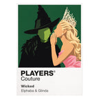 Wicked Elphaba and Glinda in contrasting green, pink and black silhouettes above the land of Oz Icon Frame artwork on white
